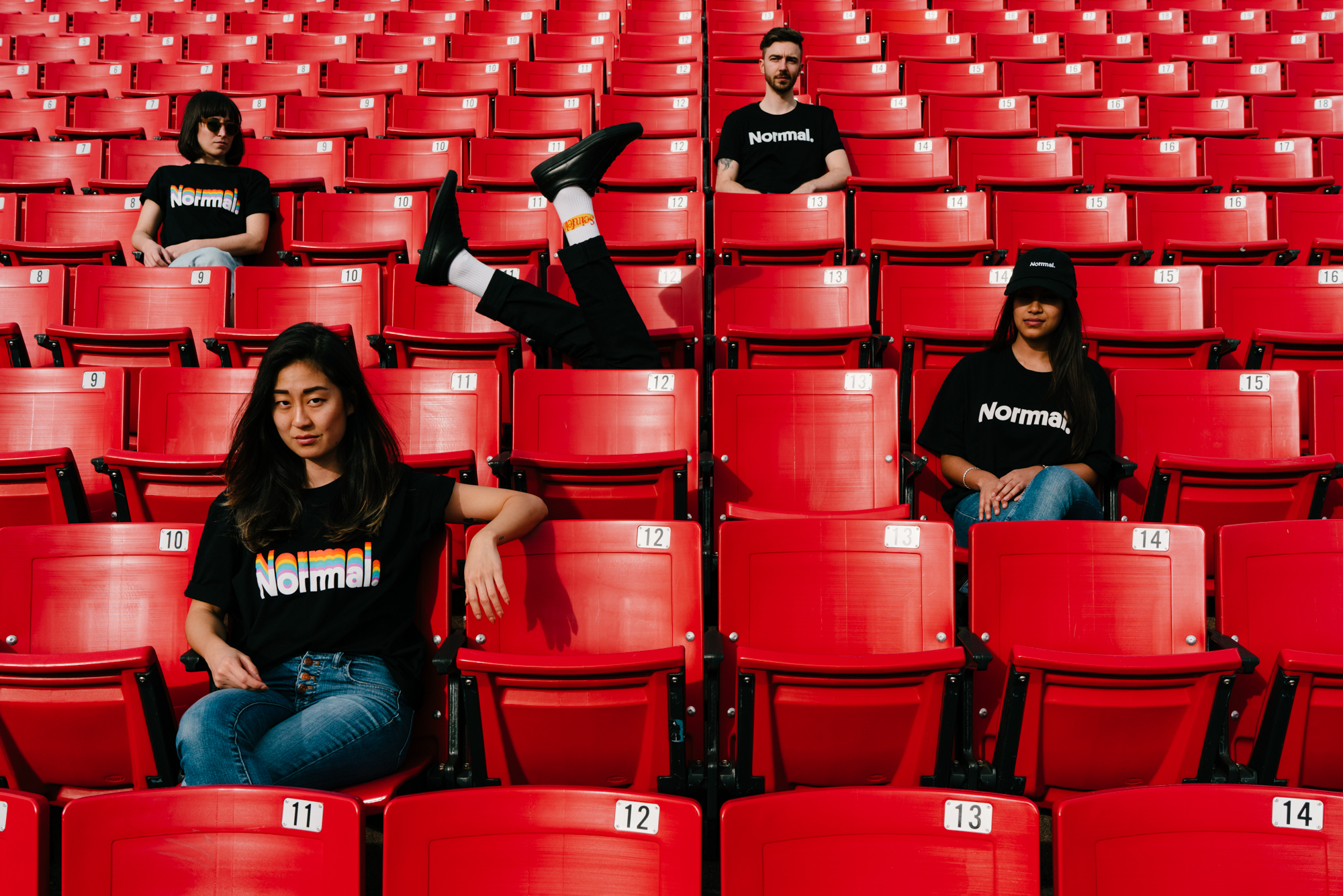 5 Normals sitting in bleachers